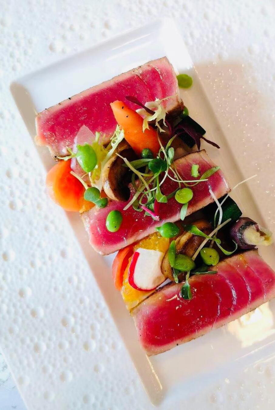 Peppered seared tuna with charred vegetables and citrus